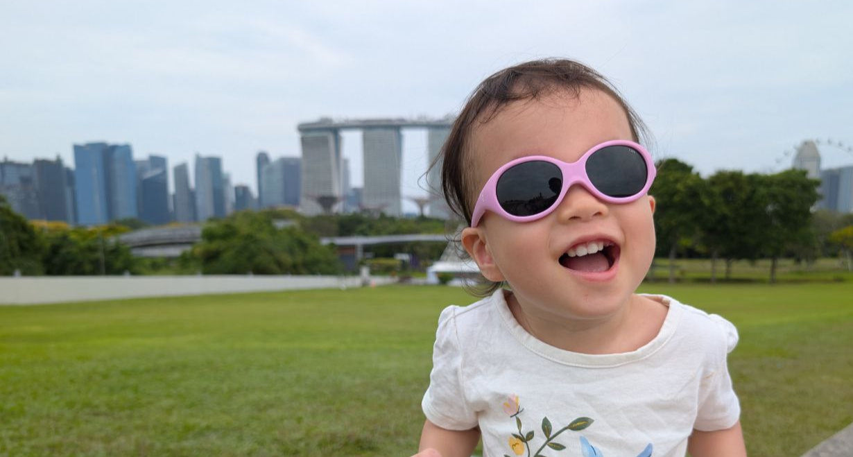 Toddler Child wearing sunglasses with Singapore cityscape in the background